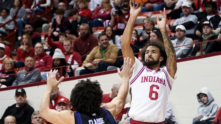 Jan 4, 2026; Bloomington, Indiana, USA; Indiana Hoosiers guard Tayton Conerway (6) shoots over Washington Huskies guard Desmond Claude (1) during the first half at Simon Skjodt Assembly Hall.