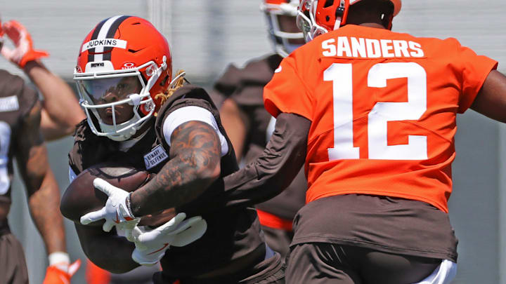 Cleveland Browns running back Quinshon Judkins (10) takes a handoff from quarterback Shedeur Sanders (12) during NFL rookie minicamp at the Cleveland Browns training facility on Friday, May 9, 2025, in Berea, Ohio.