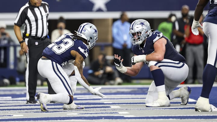 Dallas Cowboys running back Rico Dowdle celebrates with center Brock Hoffman after scoring a touchdown against the Washington Commanders.