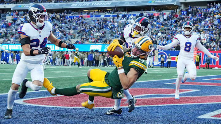Nov 16, 2025; East Rutherford, New Jersey, USA; Green Bay Packers wide receiver Christian Watson (9) makes a touchdown catch against New York Giants cornerback Korie Black (38) during the fourth quarter during the fourth quarter at MetLife Stadium.  