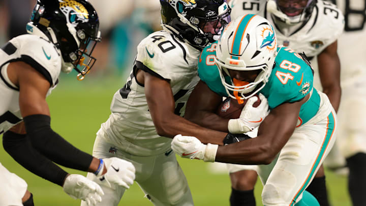 Miami Dolphins running back Aaron Shampklin (48) runs with the football against Jacksonville Jaguars cornerback Aydan White (40) during the fourth quarter at Hard Rock Stadium.