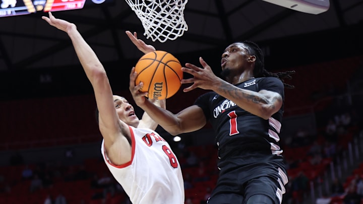 Jan 28, 2025; Salt Lake City, Utah, USA; Cincinnati Bearcats guard Day Day Thomas (1) goes to the basket against Utah Utes forward Keanu Dawes (8) during the first half at Jon M. Huntsman Center. Mandatory Credit: Rob Gray-Imagn Images Jan 28, 2025; Salt Lake City, Utah, USA; Cincinnati Bearcats guard Day Day Thomas (1) goes to the basket against Utah Utes forward Keanu Dawes (8) during the first half at Jon M. Huntsman Center. Mandatory Credit: Rob Gray-Imagn Images