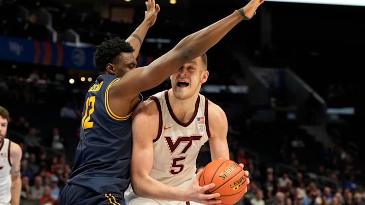 Mar 11, 2025; Charlotte, NC, USA; Virginia Tech Hokies center Patrick Wessler (5) with the ball as California Golden Bears center Mady Sissoko (12) defends in the first half at Spectrum Center. Mandatory Credit: Bob Donnan-Imagn Images