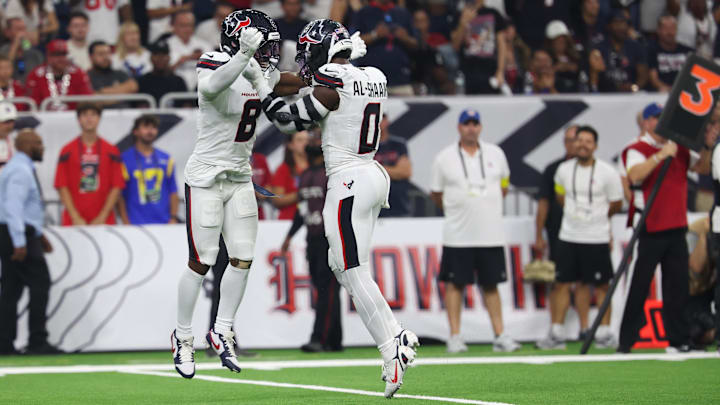 Sep 15, 2025; Houston, Texas, USA; Houston Texans safety C.J. Gardner-Johnson (8) and Houston Texans linebacker Azeez Al-Shaair (0) celebrate after making a tackle during the second quarter against the Tampa Bay Buccaneers at NRG Stadium. Mandatory Credit: Thomas Shea-Imagn Images