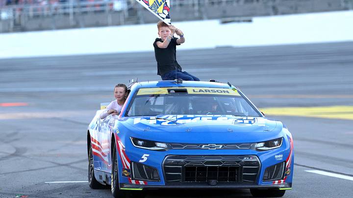 NASCAR Cup Series driver Kyle Larson (5) celebrates with his son Owen and daughter Audrey after winning the YellaWood 500 NASCAR Cup Series race at Talladega Superspeedway.  David Leong-Imagn Images