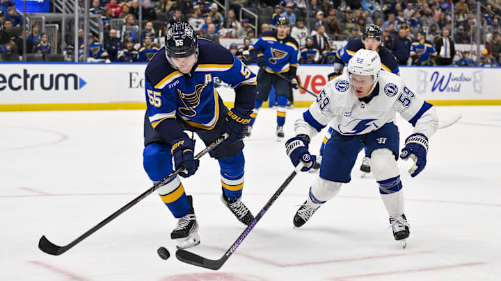 Nov 5, 2024; St. Louis, Missouri, USA;  St. Louis Blues defenseman Colton Parayko (55) and Tampa Bay Lightning center Jake Guentzel (59) battle for the puck during the third period at Enterprise Center. Mandatory Credit: Jeff Curry-Imagn Images