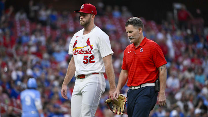 Jun 5, 2025; St. Louis, Missouri, USA;  St. Louis Cardinals starting pitcher Matthew Liberatore (52) walks off the field with a trainer after he was removed from the game with an injury during the fifth inning against the Kansas City Royals at Busch Stadium. Mandatory Credit: Jeff Curry-Imagn Images