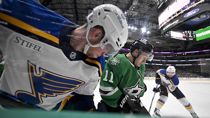 Mar 2, 2025; Dallas, Texas, USA; St. Louis Blues center Radek Faksa (12) and Dallas Stars center Logan Stankoven (11) battle for control of the puck during the first period at the American Airlines Center. Mandatory Credit: Jerome Miron-Imagn Images