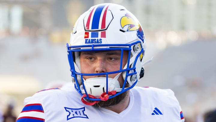 Oct 5, 2024; Tempe, Arizona, USA; Kansas Jayhawks offensive lineman Bryce Cabeldue (77) against the Arizona State Sun Devils at Mountain America Stadium. Mandatory Credit: Mark J. Rebilas-Imagn Images Oct 5, 2024; Tempe, Arizona, USA; Kansas Jayhawks offensive lineman Bryce Cabeldue (77) against the Arizona State Sun Devils at Mountain America Stadium. Mandatory Credit: Mark J. Rebilas-Imagn Images
