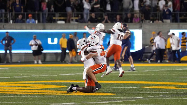 Oct 5, 2024; Berkeley, California, USA; Miami Hurricanes wide receiver Joshisa Trader (center left) and wide receiver Xavier Restrepo (center right) celebrate after defeating the California Golden Bears at California Memorial Stadium. Mandatory Credit: Darren Yamashita-Imagn Images