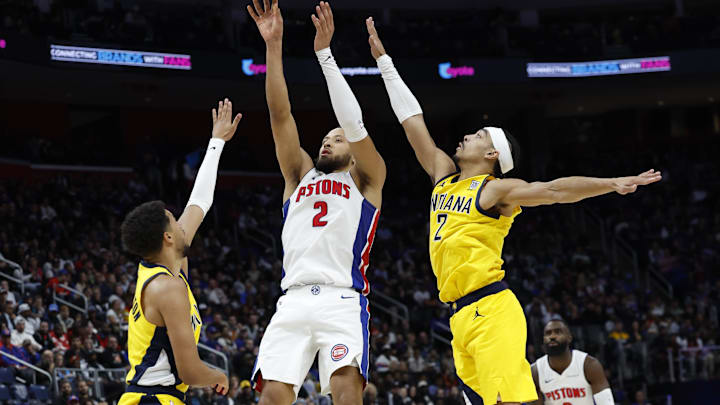 Oct 23, 2024; Detroit, Michigan, USA; Detroit Pistons guard Cade Cunningham (2) shoots on Indiana Pacers guard Andrew Nembhard (2) in the first half at Little Caesars Arena. Mandatory Credit: Rick Osentoski-Imagn Images
