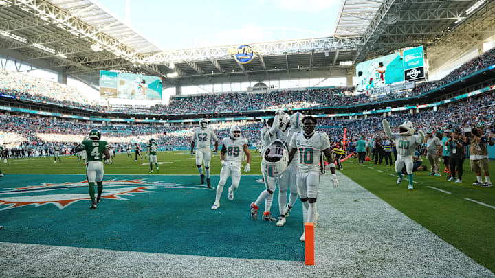 Miami Dolphins wide receiver Tyreek Hill (10) and teammates celebrate after defeating the New York Jets during overtime at Hard Rock Stadium.