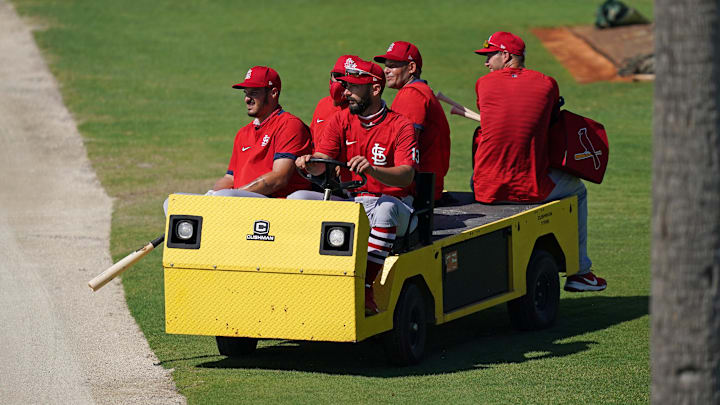 Feb 26, 2021; Jupiter, Florida, USA; St. Louis Cardinals third baseman Nolan Arenado (28), third baseman Matt Carpenter (13), bullpen catcher Kleininger Teran (76), catcher Yadier Molina (4), and first baseman Paul Goldschmidt (46) ride on a cart during spring training workouts at Roger Dean Stadium. Mandatory Credit: Jasen Vinlove-Imagn Images Feb 26, 2021; Jupiter, Florida, USA; St. Louis Cardinals third baseman Nolan Arenado (28), third baseman Matt Carpenter (13), bullpen catcher Kleininger Teran (76), catcher Yadier Molina (4), and first baseman Paul Goldschmidt (46) ride on a cart during spring training workouts at Roger Dean Stadium. Mandatory Credit: Jasen Vinlove-Imagn Images