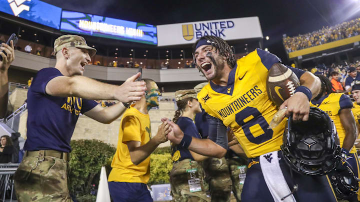 Sep 16, 2023; Morgantown, West Virginia, USA; West Virginia Mountaineers quarterback Nicco Marchiol (8) celebrates with fans after defeating the Pittsburgh Panthers at Mountaineer Field at Milan Puskar Stadium. Mandatory Credit: Ben Queen-Imagn Images