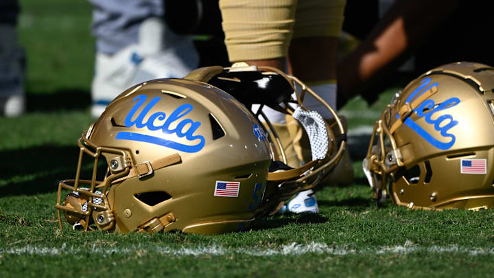 Nov 30, 2024; Pasadena, California, USA; UCLA Bruins helmets during pregame warmups before playing the Fresno State Bulldogs at Rose Bowl. Mandatory Credit: Robert Hanashiro-Imagn Images