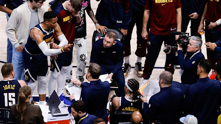 Apr 21, 2025; Denver, Colorado, USA; Denver Nuggets guard Russell Westbrook (4) talks as interim head coach David Adelman looks on in the fourth quarter against the Los Angeles Clippers during game two of first round for the 2025 NBA Playoffs at Ball Arena. Mandatory Credit: Isaiah J. Downing-Imagn Images