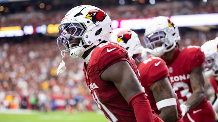 Sep 29, 2024; Glendale, Arizona, USA; Arizona Cardinals cornerback Garrett Williams (21) celebrates an interception with teammates against the Washington Commanders in the first half at State Farm Stadium. Mandatory Credit: Mark J. Rebilas-Imagn Images