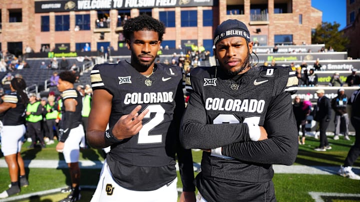 Nov 29, 2024; Boulder, Colorado, USA; Colorado Buffaloes quarterback Shedeur Sanders (2) and safety Shilo Sanders (21) pose for a photo before the game against the Oklahoma State Cowboys at Folsom Field. Mandatory Credit: Ron Chenoy-Imagn Images