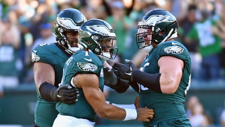 Lane Johnson and Jordan Mailata help Jalen Hurts celebrate. Lane Johnson and Jordan Mailata help Jalen Hurts celebrate.