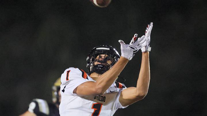 Oviedo Jordan Donahoo (1) tries to catch the pass under pressure from Oviedo Bruce Slivinski (5) during the 2025 FHSAA Football 6A quarter final at Citizens Field in Gainesville, FL on Thursday, November 13, 2025. [Alan Youngblood/Gainesville Sun]