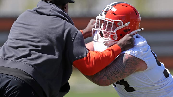 Cleveland Browns defensive tackle Mason Graham (94) works with defensive line coach Jacques Cesaire during NFL rookie minicamp at the Cleveland Browns training facility.