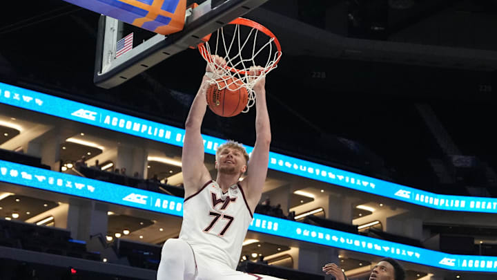 Mar 10, 2026; Charlotte, N.C.; Virginia Tech center Antonio Dorn (77) scores as Wake Forest guard Myles Colvin (6) defends.