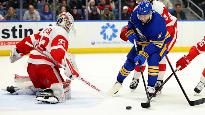Dec 9, 2024; Buffalo, New York, USA;  Buffalo Sabres left wing Jason Zucker (17) looks to take a shot on Detroit Red Wings goaltender Sebastian Cossa (33) during the second period at KeyBank Center. Mandatory Credit: Timothy T. Ludwig-Imagn Images