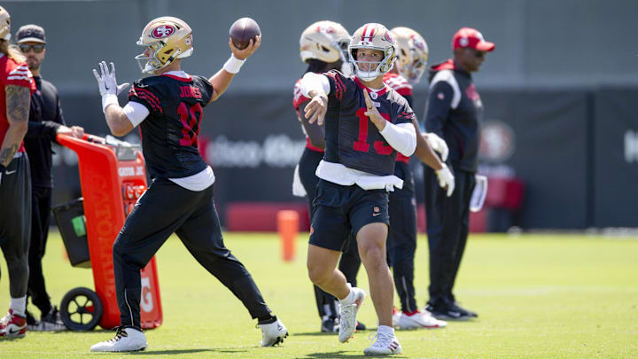 Jun 11, 2025; Santa Clara, CA, USA; San Francisco 49ers quarterbacks Mac Jones (10) and Brock Purdy (13) work on passing drills during a team OTA at Levi's Stadium. Mandatory Credit: D. Ross Cameron-Imagn Images Jun 11, 2025; Santa Clara, CA, USA; San Francisco 49ers quarterbacks Mac Jones (10) and Brock Purdy (13) work on passing drills during a team OTA at Levi's Stadium. Mandatory Credit: D. Ross Cameron-Imagn Images