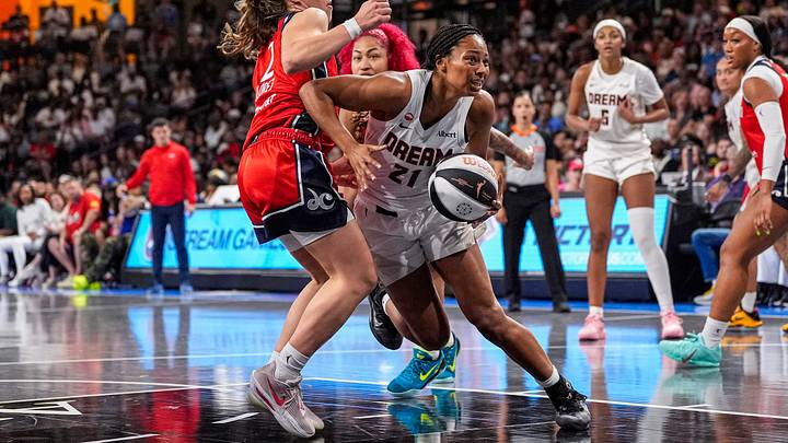 Jun 6, 2026; College Park, Georgia, USA; Atlanta Dream guard Indya Nivar (21) tries to get past Washington Mystics forward Nyla Harris (2) at Gateway Center at College Park. Mandatory Credit: Dale Zanine-Imagn Images