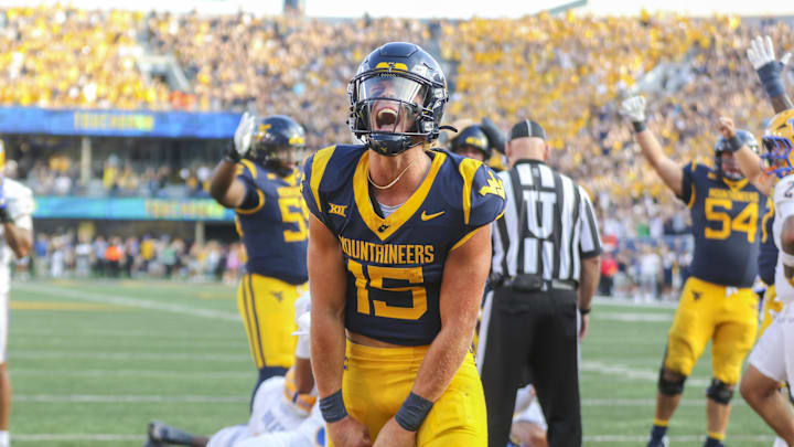 Sep 13, 2025; Morgantown, West Virginia, USA; West Virginia Mountaineers quarterback Scotty Fox Jr. (15) celebrates after a touchdown during the third quarter against the Pittsburgh Panthers at Milan Puskar Stadium. Mandatory Credit: Ben Queen-Imagn Images