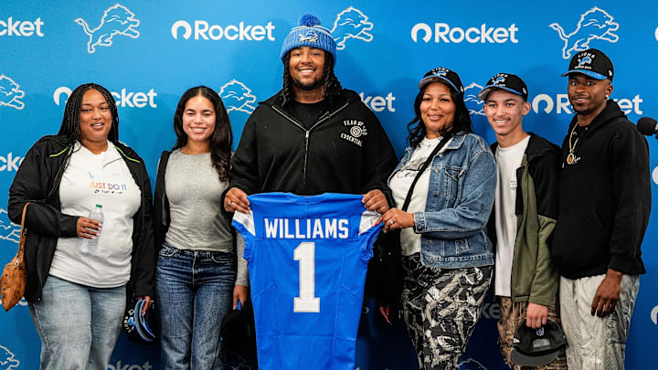 Detroit Lions first round draft selection Tyleik Williams, center, poses for a photo with his family during the introduction press conference at Meijer Performance Center In Allen Park on Friday, April 25, 2025.