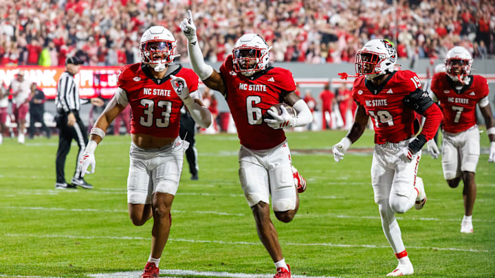Nov 21, 2025; Raleigh, North Carolina, USA; NC State Wolfpack defensive back Devon Marshall (6) celebrates a down and runs towards the JROTC to celebrate during the first half of the game against Florida State Seminoles at Carter-Finley Stadium. Mandatory Credit: Jaylynn Nash-Imagn Images Nov 21, 2025; Raleigh, North Carolina, USA; NC State Wolfpack defensive back Devon Marshall (6) celebrates a down and runs towards the JROTC to celebrate during the first half of the game against Florida State Seminoles at Carter-Finley Stadium. Mandatory Credit: Jaylynn Nash-Imagn Images
