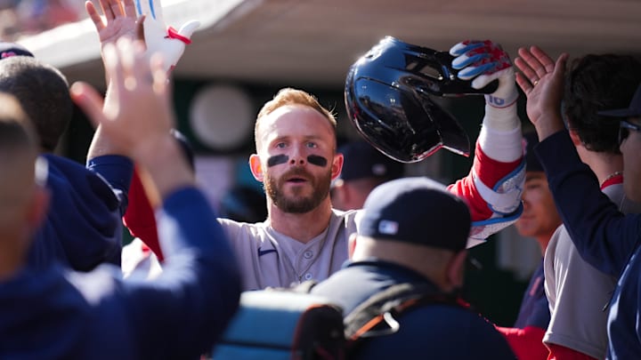 Mar 28, 2026; Cincinnati, Ohio, USA;  Boston Red Sox shortstop Trevor Story (10) high-fives teammates after hitting a solo home run against the Cincinnati Reds in the third inning at Great American Ball Park. Mandatory Credit: Aaron Doster-Imagn Images