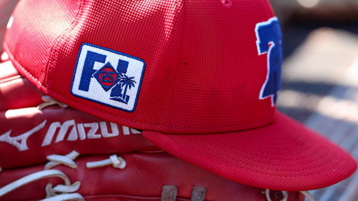 A red Philadelphia Phillies hat with a logo of the Liberty Bell in the front. 