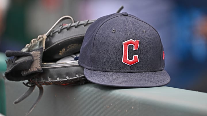 Jun 27, 2024; Kansas City, Missouri, USA; A general view a Cleveland Guardians hat and glove on the dugout railing before a game against the Kansas City Royals at Kauffman Stadium. Mandatory Credit: Peter Aiken-Imagn Images Jun 27, 2024; Kansas City, Missouri, USA; A general view a Cleveland Guardians hat and glove on the dugout railing before a game against the Kansas City Royals at Kauffman Stadium. Mandatory Credit: Peter Aiken-Imagn Images