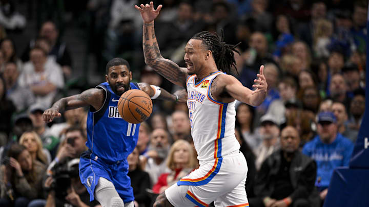 Jan 17, 2025; Dallas, Texas, USA; Dallas Mavericks guard Kyrie Irving (11) and Oklahoma City Thunder forward Jaylin Williams (6) battle for control of the loose ball during the second half at the American Airlines Center. Mandatory Credit: Jerome Miron-Imagn Images