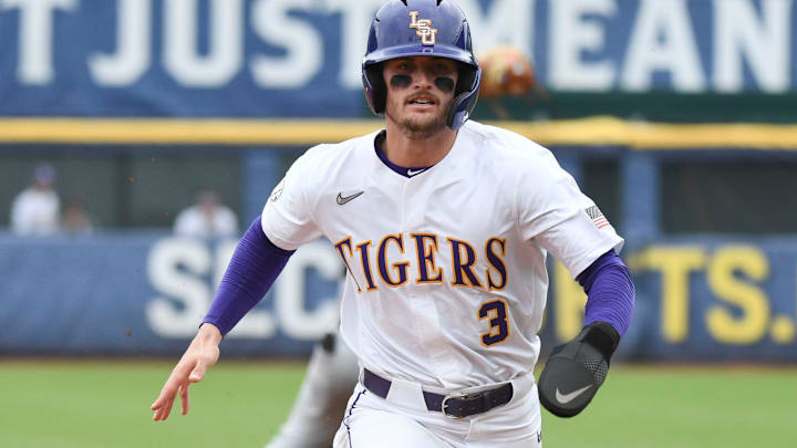 LSU base runner Dylan Crews tags and moves to third on a sacrifice fly against South Carolina during