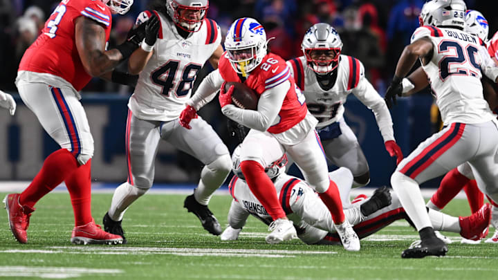 Dec 22, 2024; Orchard Park, New York, USA; Buffalo Bills running back Ty Johnson (26) runs past New England Patriots linebacker Jahlani Tavai (48), safety Jaylinn Hawkins (21) and cornerback Isaiah Bolden (29) in the fourth quarter at Highmark Stadium