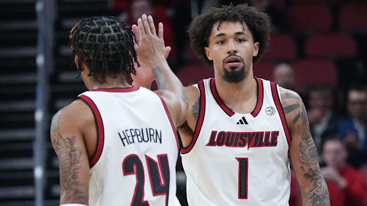 Louisville's J'Vonne Hadley (1) high fives Chucky Hepburn (24) against Morehead State at the KFC Yum! Center.