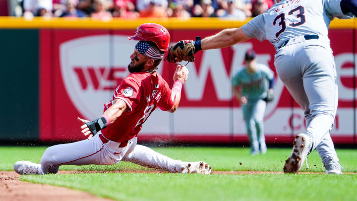 Cincinnati Reds outfielder Nick Martini (23) is tagged out by Detroit Tigers second baseman Colt Keith (33) in the second inning at Great American Ball Park in Cincinnati on Saturday, July 6, 2024.