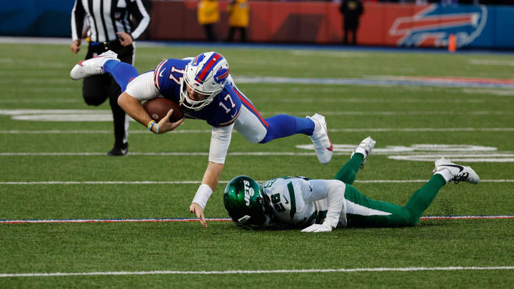 Buffalo Bills quarterback Josh Allen (17) is tackled by New York Jets running back Israel Abanikanda (25) after a short gain. Buffalo Bills quarterback Josh Allen (17) is tackled by New York Jets running back Israel Abanikanda (25) after a short gain.