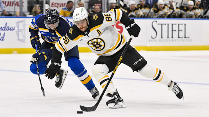 Nov 12, 2024; St. Louis, Missouri, USA;  Boston Bruins right wing David Pastrnak (88) skates against St. Louis Blues defenseman Pierre-Olivier Joseph (77) during the third period at Enterprise Center. Mandatory Credit: Jeff Curry-Imagn Images