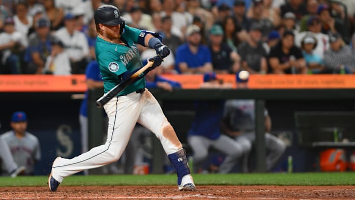 Aug 10, 2024; Seattle, Washington, USA; Seattle Mariners first baseman Justin Turner (2) hits an RBI single against the New York Mets during the seventh inning at T-Mobile Park.
