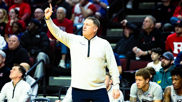 Penn State Nittany Lions men's basketball coach Mike Rhoades calls out a play to his team during the game against Rutgers. 
