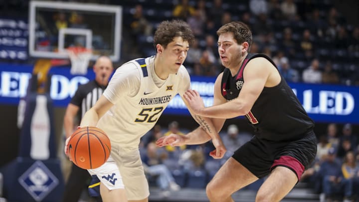 Nov 17, 2025; Morgantown, West Virginia, USA; West Virginia Mountaineers guard Treysen Eaglestaff (52) drives against Lafayette Leopards forward Andrew Phillips (21) during the second half at WVU Coliseum. Mandatory Credit: Ben Queen-Imagn Images