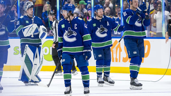 May 20, 2024; Vancouver, British Columbia, CAN; Vancouver Canucks defenseman Quinn Hughes (43) and forward J.T. Miller (9) and defenseman Nikita Zadorov (91) and goalie Arturs Silvos (31) wave to the crowd after the Edmonton Oilers win in game seven of the second round of the 2024 Stanley Cup Playoffs at Rogers Arena. Mandatory Credit: Bob Frid-USA TODAY Sports