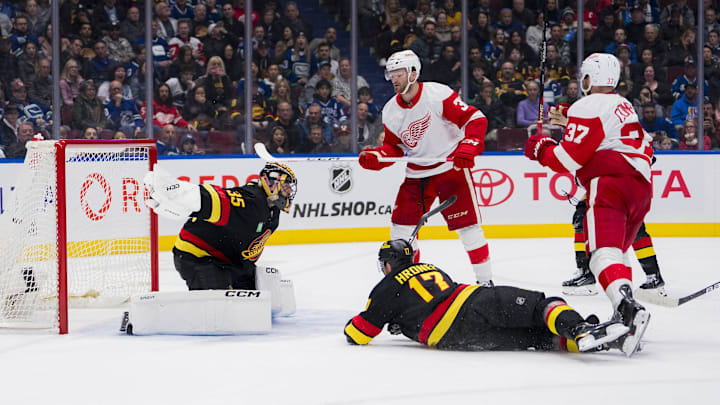 Detroit Red Wings forward Christian Fischer (36) and J.T. Compher crashes the net hard.