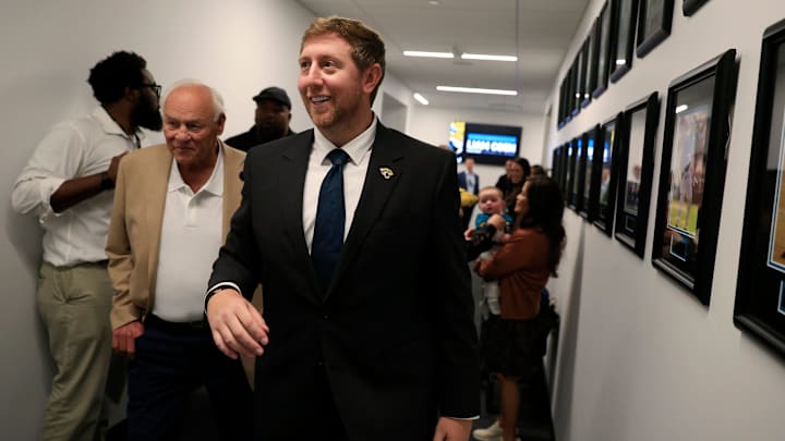 Liam Coen, center, walks with his father Tim Coen, left, as Edna Garcia, mother-in-law, right, holds son Callahan Coen, 7 months, after speaking and being introduced as the new Jacksonville Jaguars head coach during a press conference Monday, Jan. 27, 2025 at the Miller Electric Center in Jacksonville, Fla. Liam Coen, center, walks with his father Tim Coen, left, as Edna Garcia, mother-in-law, right, holds son Callahan Coen, 7 months, after speaking and being introduced as the new Jacksonville Jaguars head coach during a press conference Monday, Jan. 27, 2025 at the Miller Electric Center in Jacksonville, Fla.