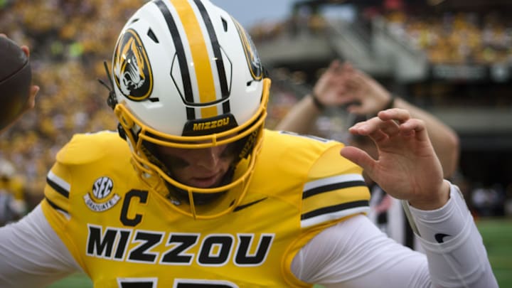 Sep 21, 2024; Columbia, Missouri, USA; Missouri Tigers quarterback Brady Cook maintains his balance as he's knocked out of bounce on a run during a game against the Vanderbilt Commodores at Faurot Field at Memorial Stadium Sep 21, 2024; Columbia, Missouri, USA; Missouri Tigers quarterback Brady Cook maintains his balance as he's knocked out of bounce on a run during a game against the Vanderbilt Commodores at Faurot Field at Memorial Stadium