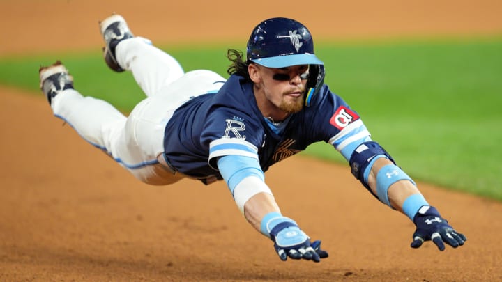 Jun 7, 2024; Kansas City, Missouri, USA; Kansas City Royals shortstop Bobby Witt Jr. (7) slides into third base for a triple during the ninth inning against the Seattle Mariners at Kauffman Stadium. Mandatory Credit: Jay Biggerstaff-USA TODAY Sports